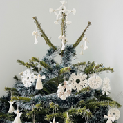 A screenshot of an online craft pattern listing for a Macrame Sculpture Paper PDF by designer Wilma Robertson. The page shows a central mockup of a decorated Christmas tree made from white macrame cords, alongside product details, pricing, and related search suggestions.