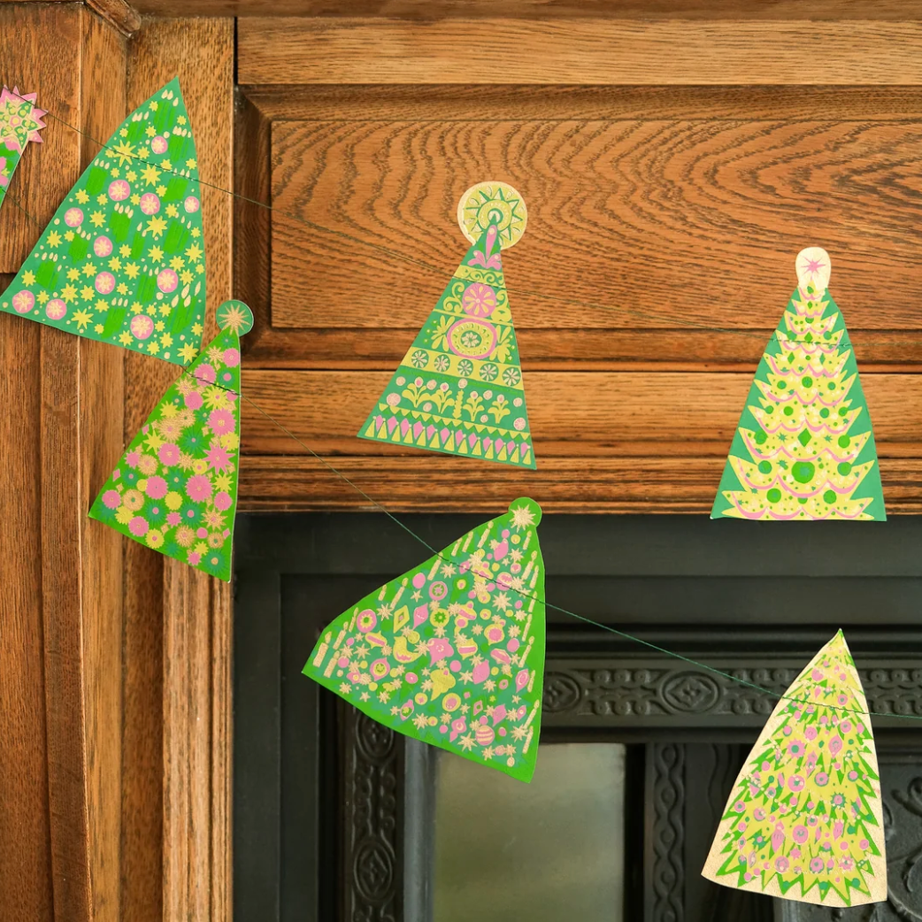 A screenshot of a web page showing a product listing for 'Sewn Garland' by eastendpress, featuring green and white patterned triangular garlands hanging on a wooden door. The screenshot is taken from a desktop computer with the Chrome browser open, showing the macOS menu bar and dock at the bottom.