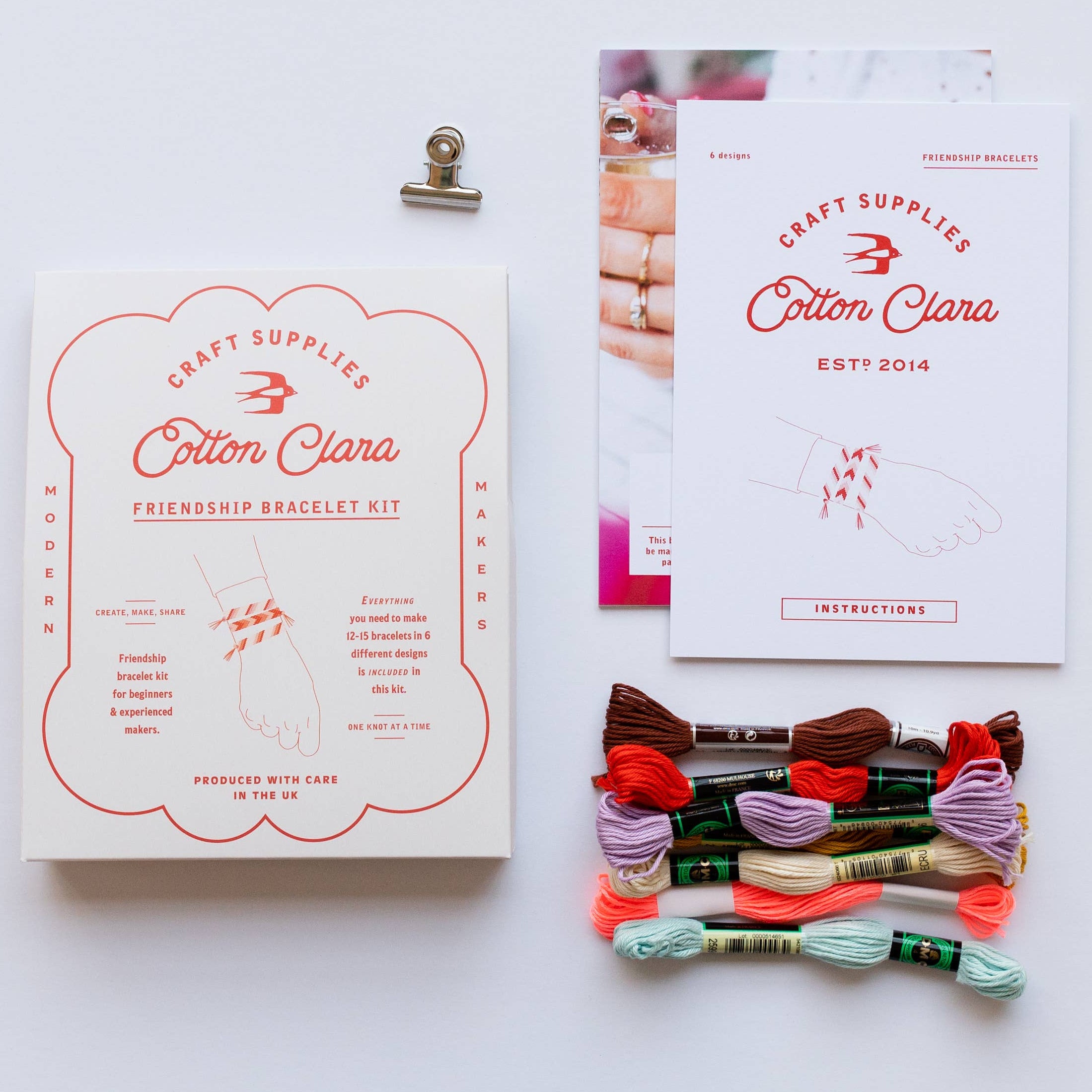 Cotton Clara craft supplies with friendship bracelet kit and materials on a white background