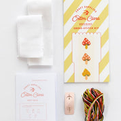 Cross-stitch kit with materials on a white background