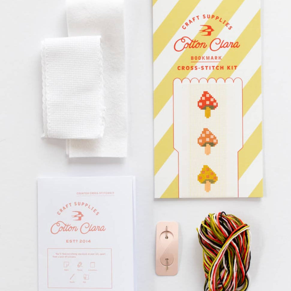 Cross-stitch kit with materials on a white background