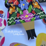 Colorful paper doll with floral dress and butterfly wings on a white background, featuring 'Butterfly Women by Kitty Kenda'.