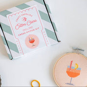 Cross stitch kit with hoop and embroidery design on a white surface