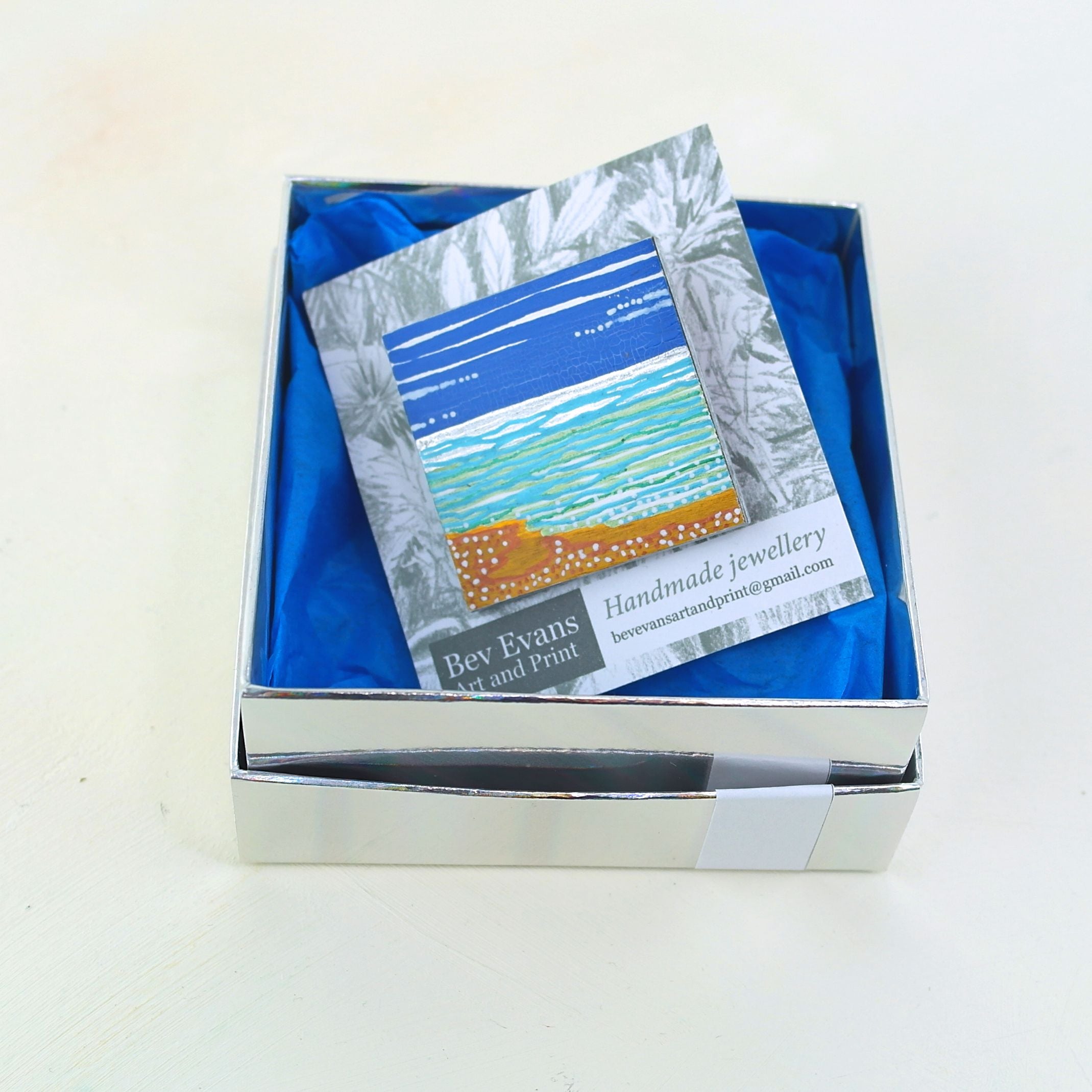 Jewellery box with a branded card inside on a white background