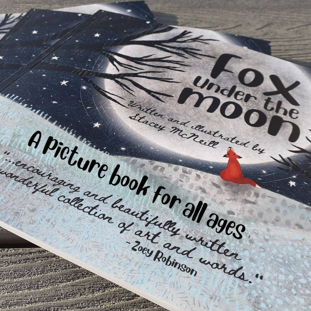 Children's book titled 'Fox under the moon' on a wooden surface