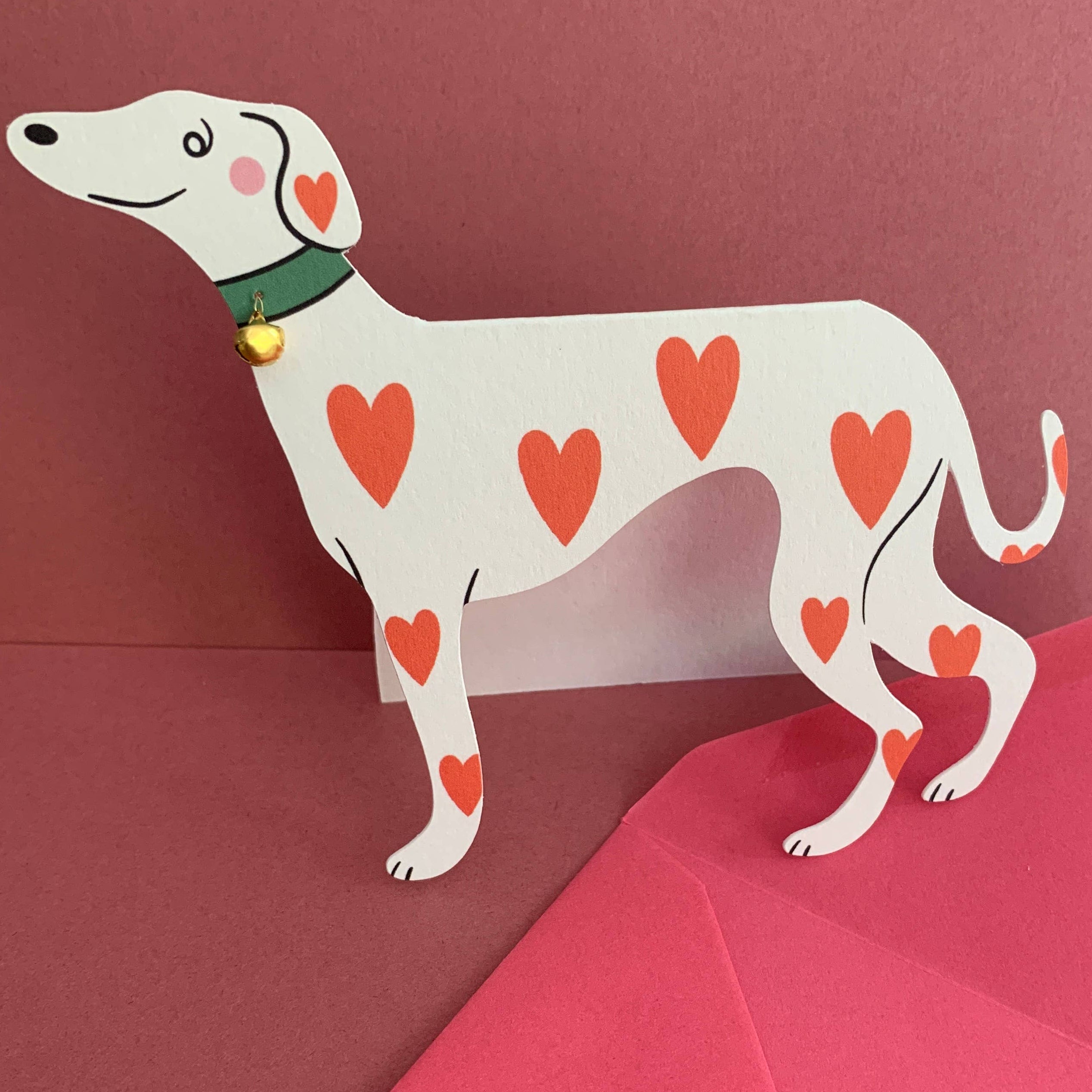 Cardboard dog with heart patterns on a red background
