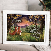 Framed artwork of two foxes under a tree with a quote, placed on a surface.