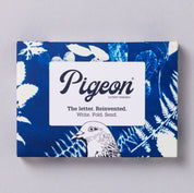 Pigeon product packaging with blue floral design on a gray background