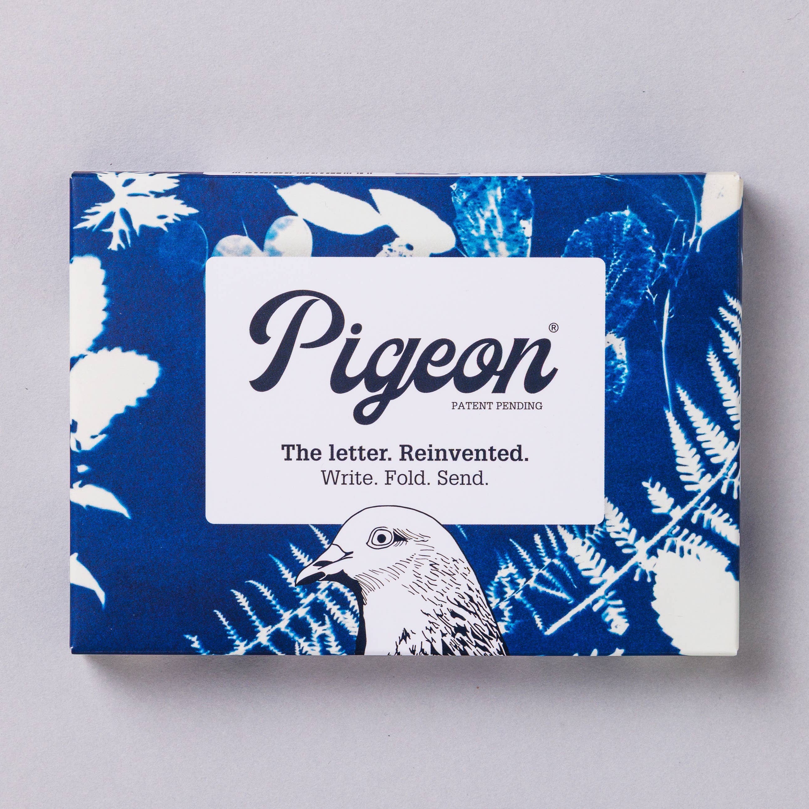 Pigeon product packaging with blue floral design on a gray background