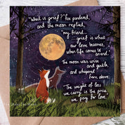 Greeting card with foxes under a moonlit sky and poetic text on a wooden surface.