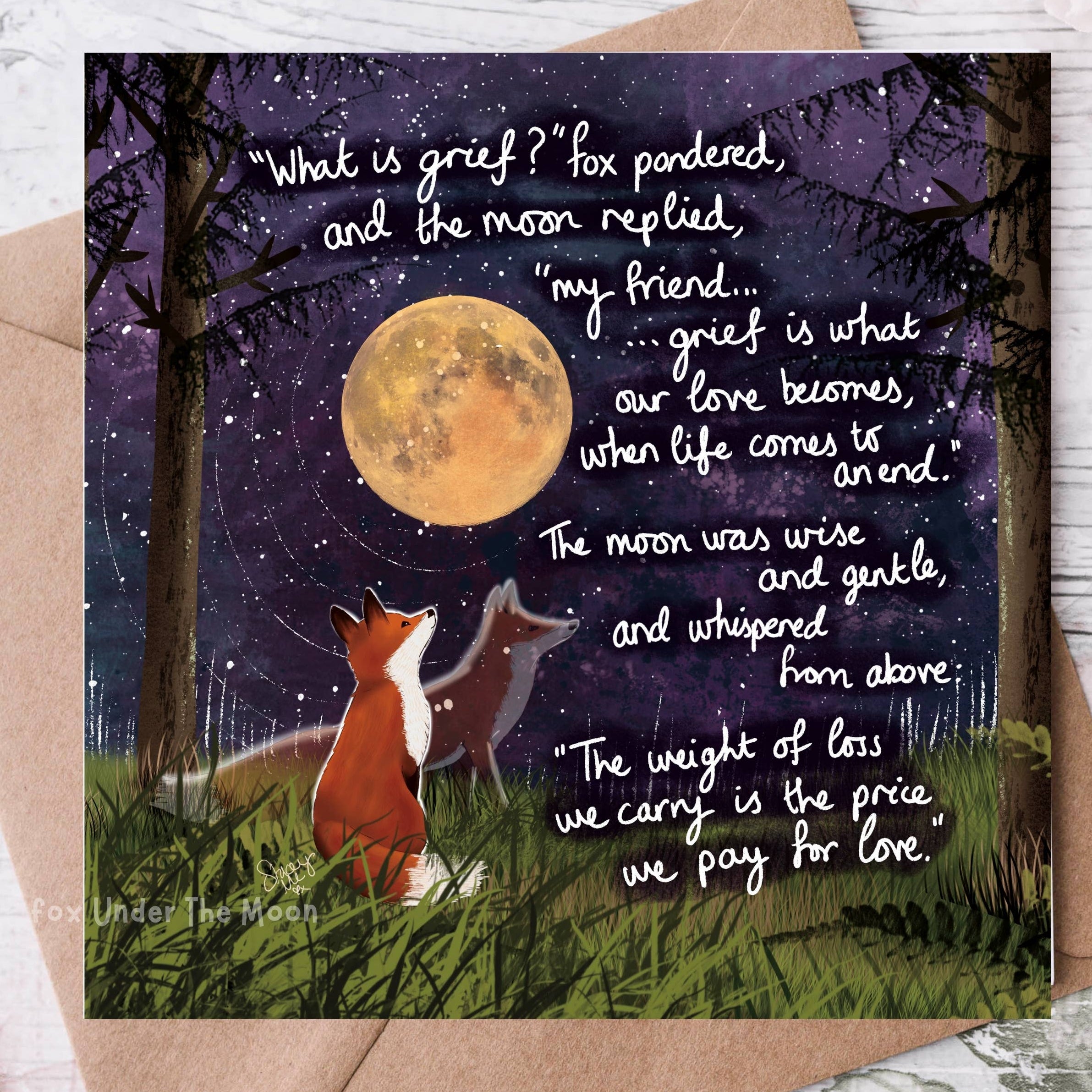 Greeting card with foxes under a moonlit sky and poetic text on a wooden surface.