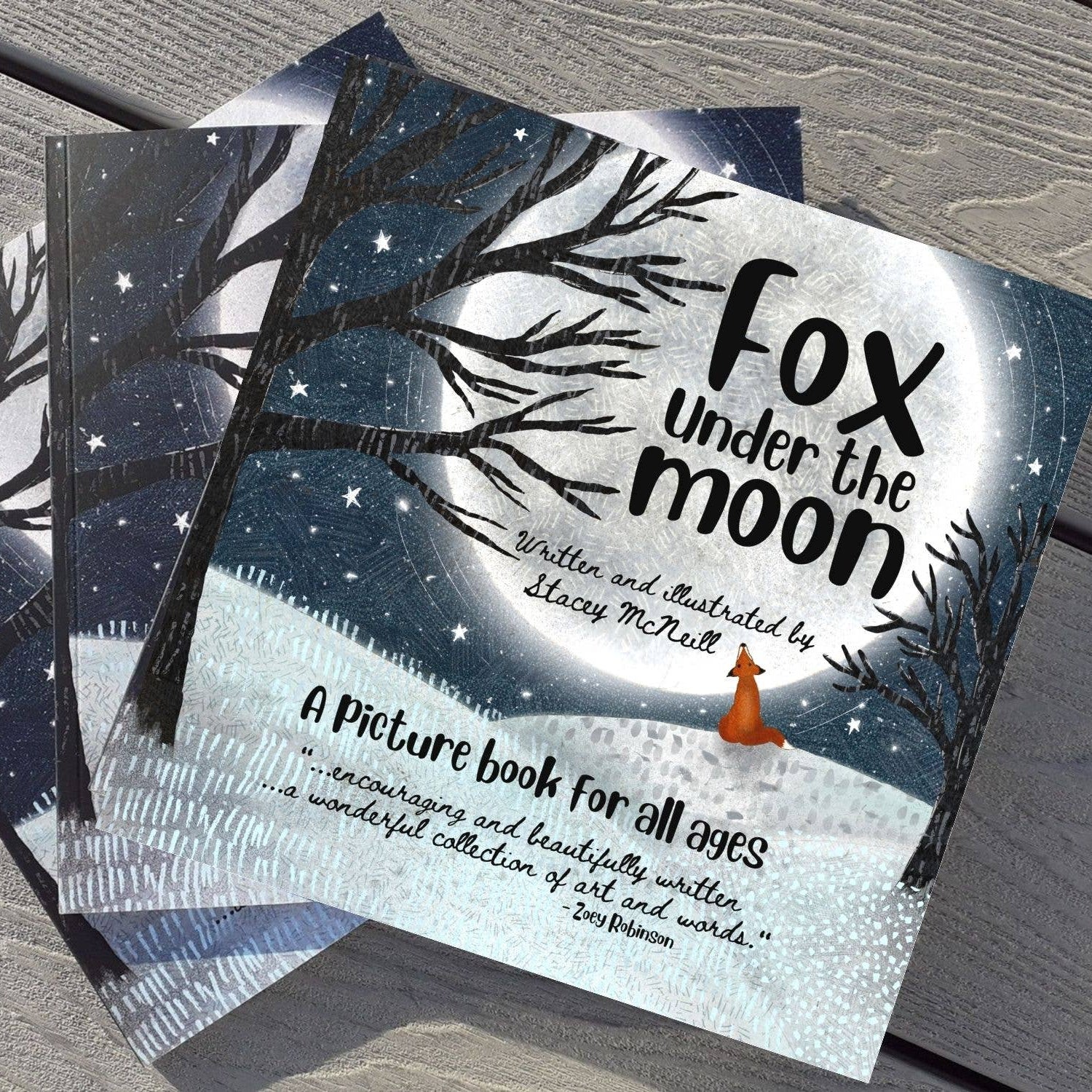 Children's book titled 'Fox under the moon' on a wooden surface
