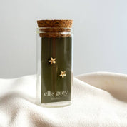Jar of 'ellis grey' tea with cork lid on a white surface