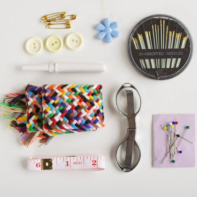 Collection of sewing and crafting tools on a white background