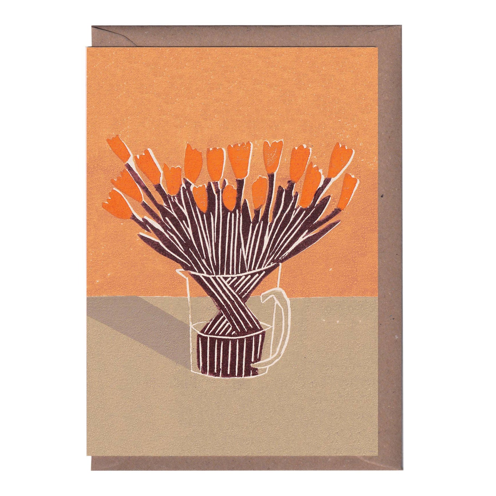 A greeting card featuring a linocut print of an orange tree in a vase, with a beige background and a kraft envelope.