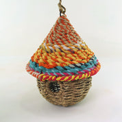 Bird nester in grass and sari fabric, pod shape