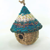 Bird nester in grass and sari fabric, pod shape