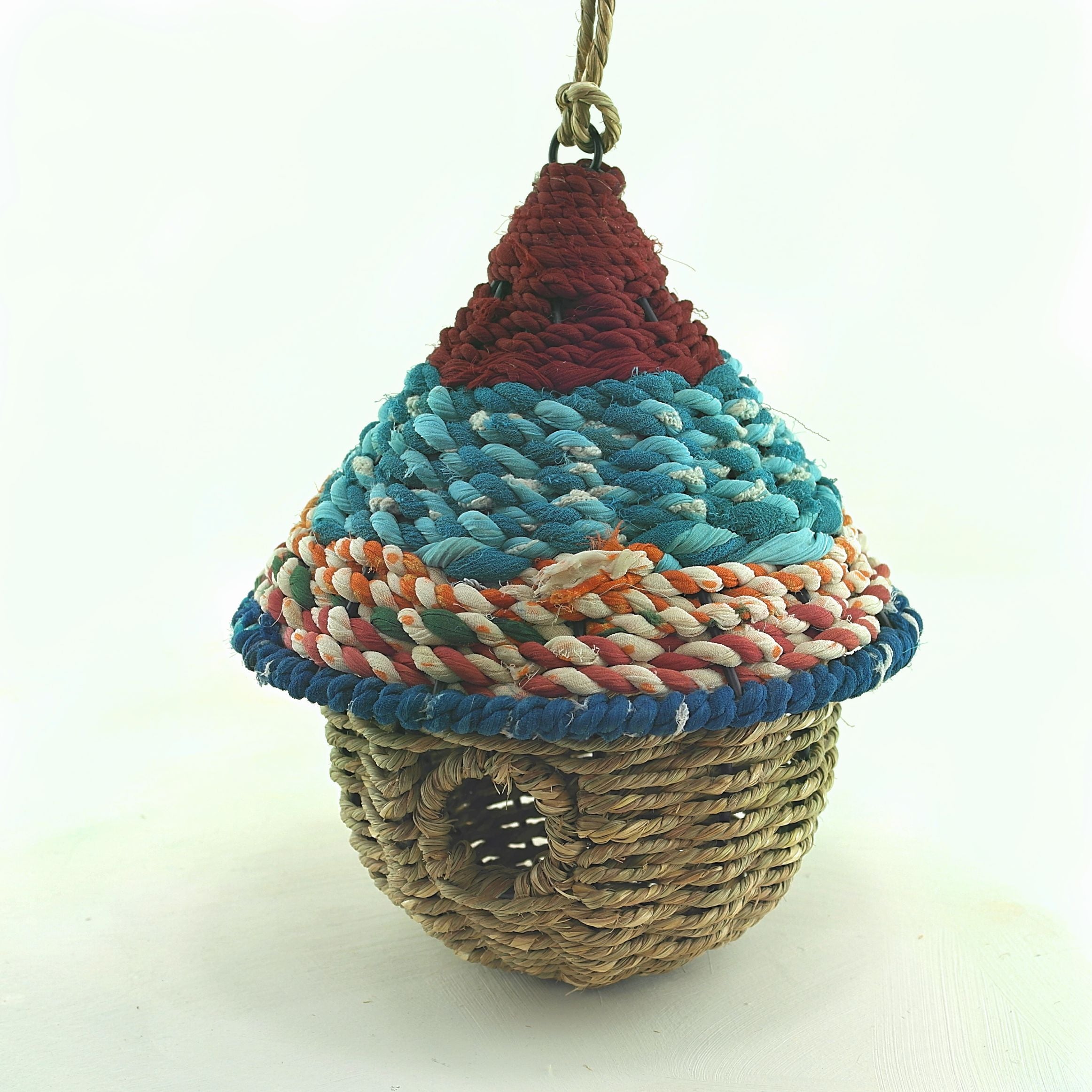 Bird nester in grass and sari fabric, pod shape